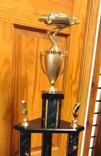 A trophy sitting on top of a wooden table.