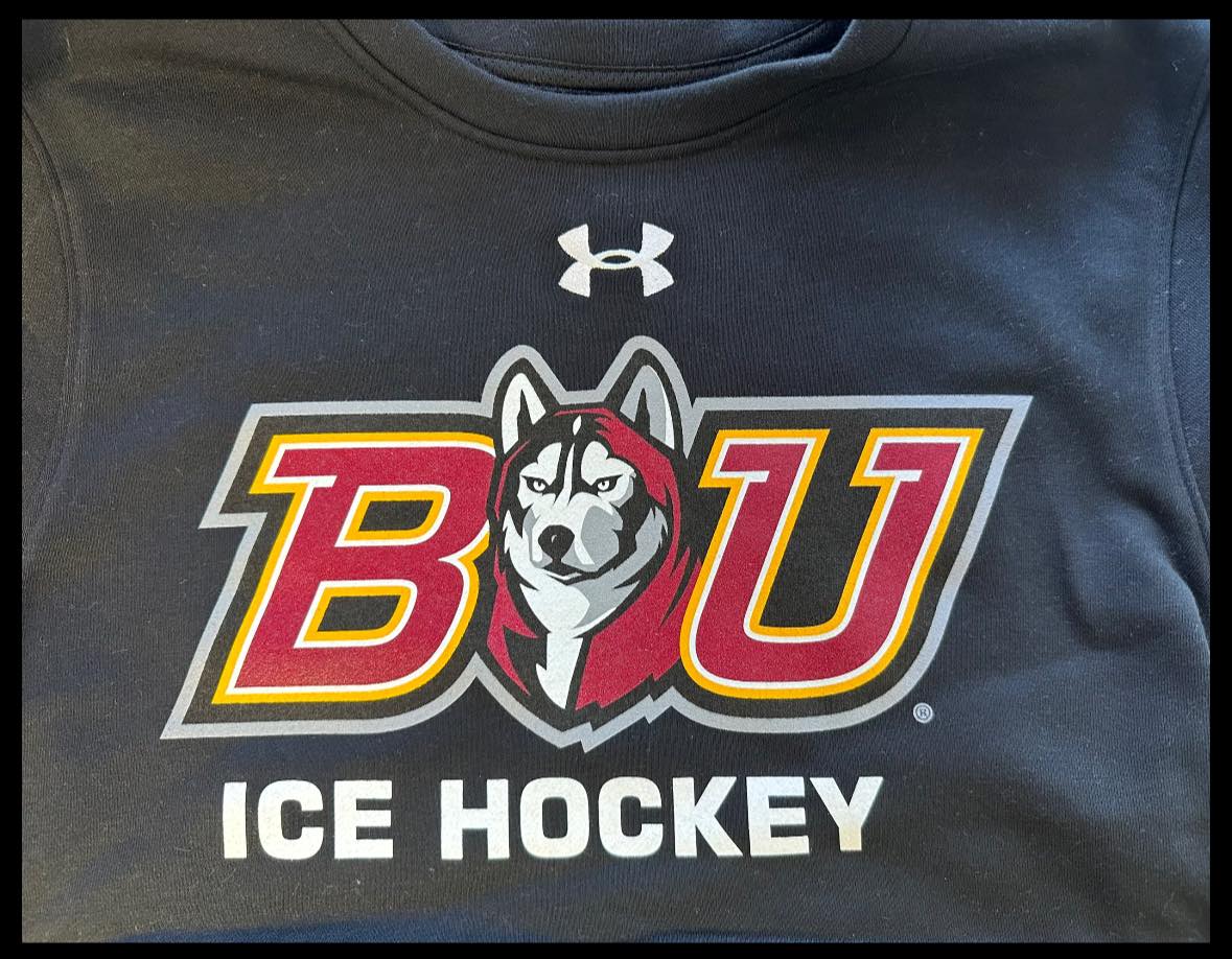 A black shirt with the logo of bu ice hockey.